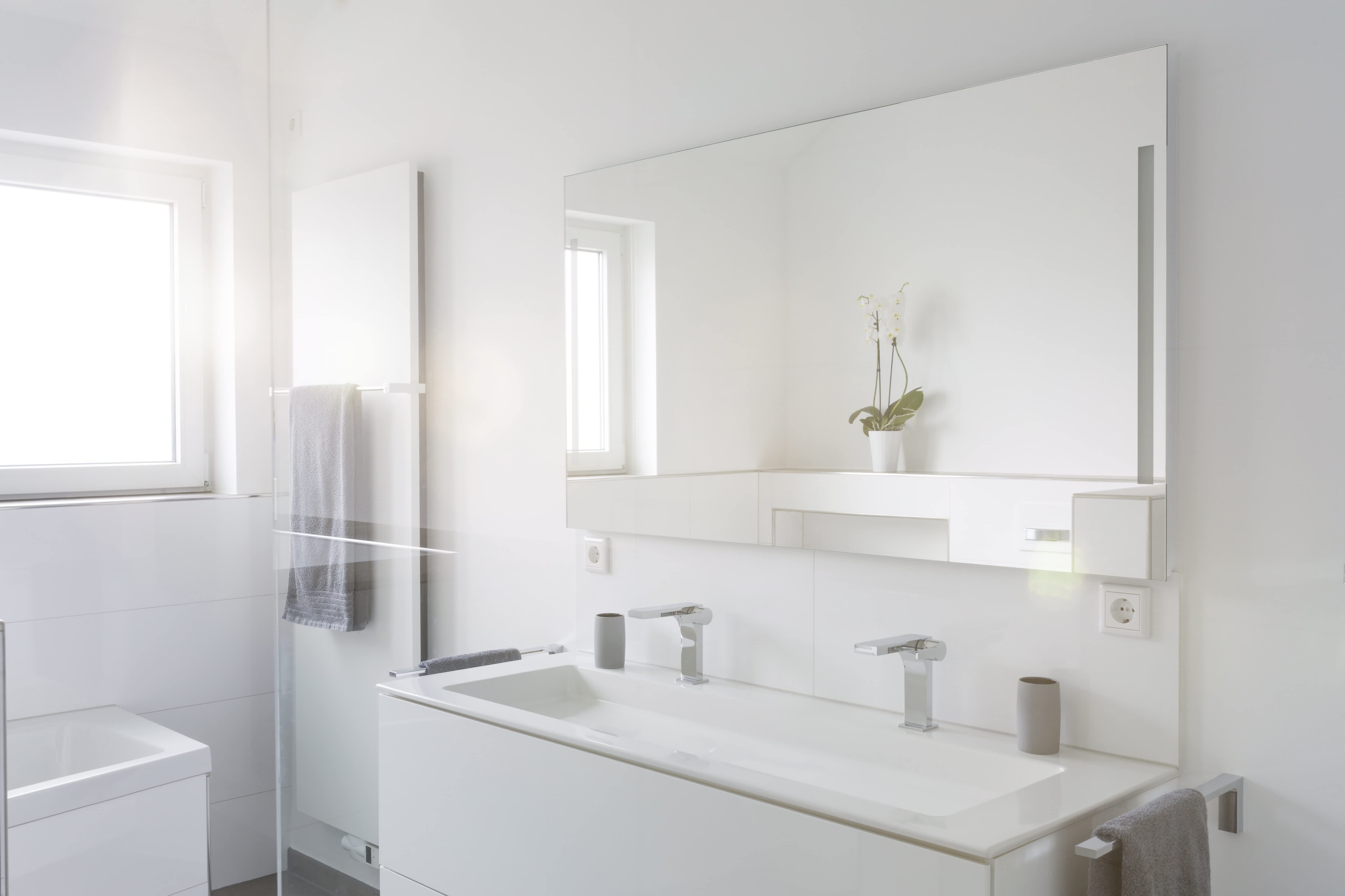 Modern bathroom with frameless mirror
