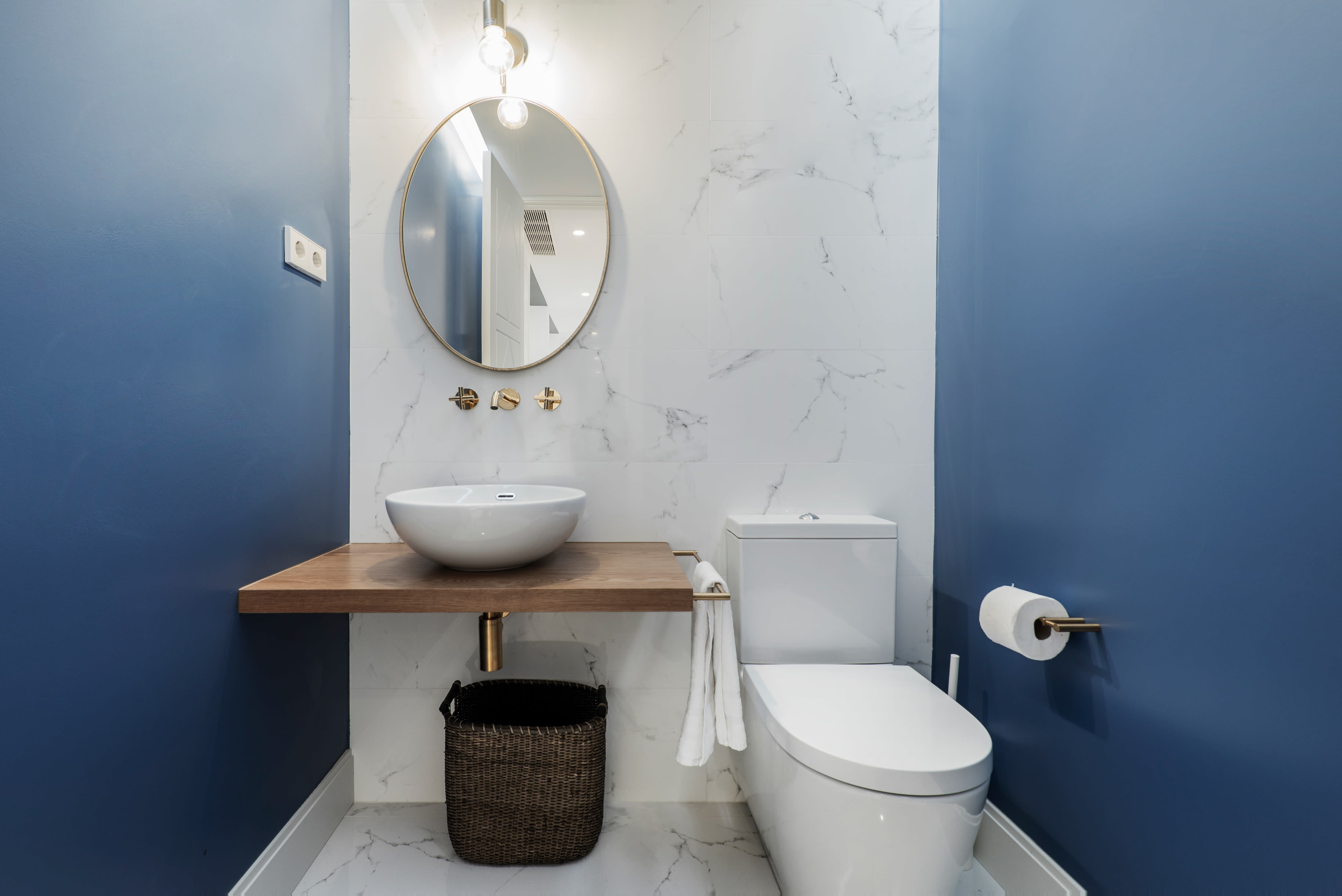 Oval mirror in modern bathroom