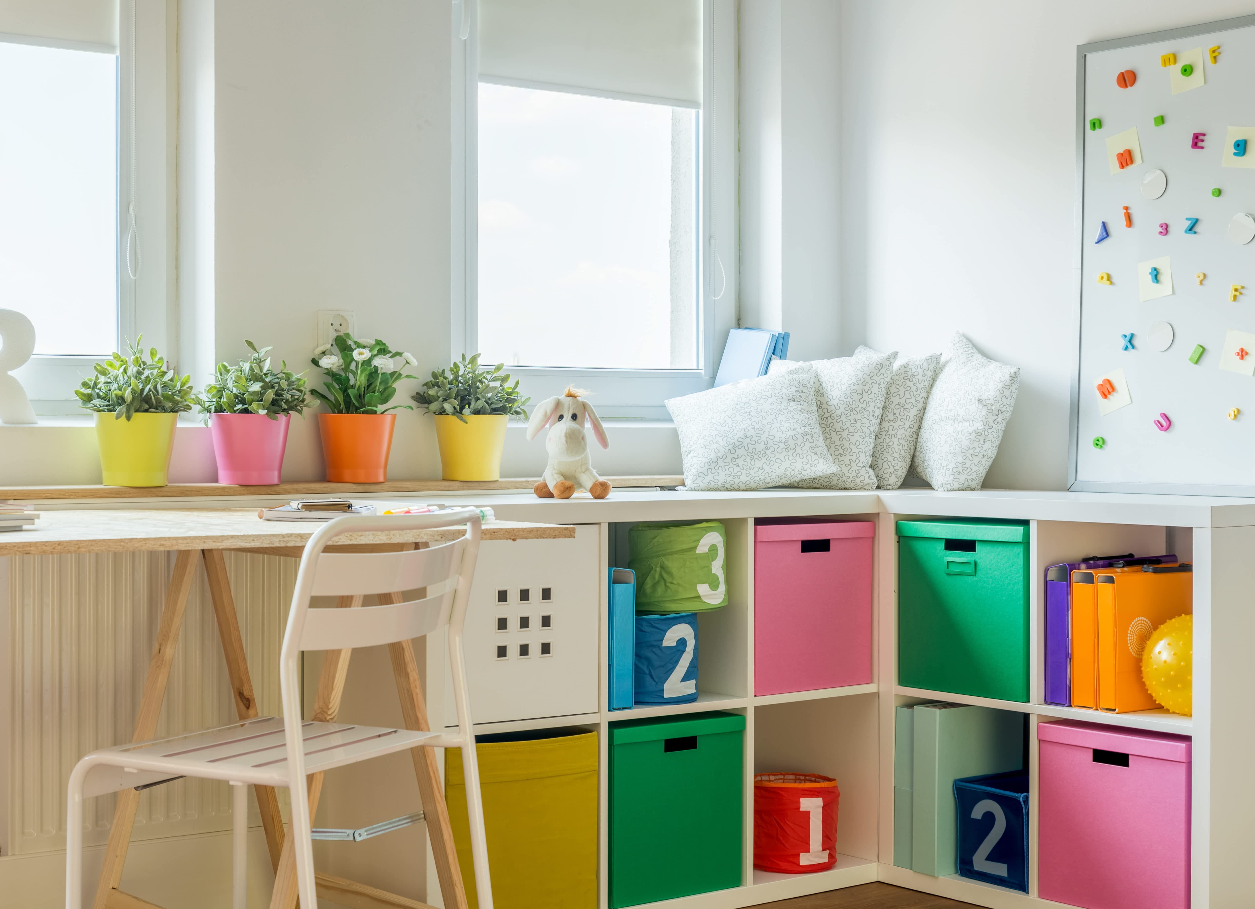 A neatly organized kid’s playroom with colorful storage bins