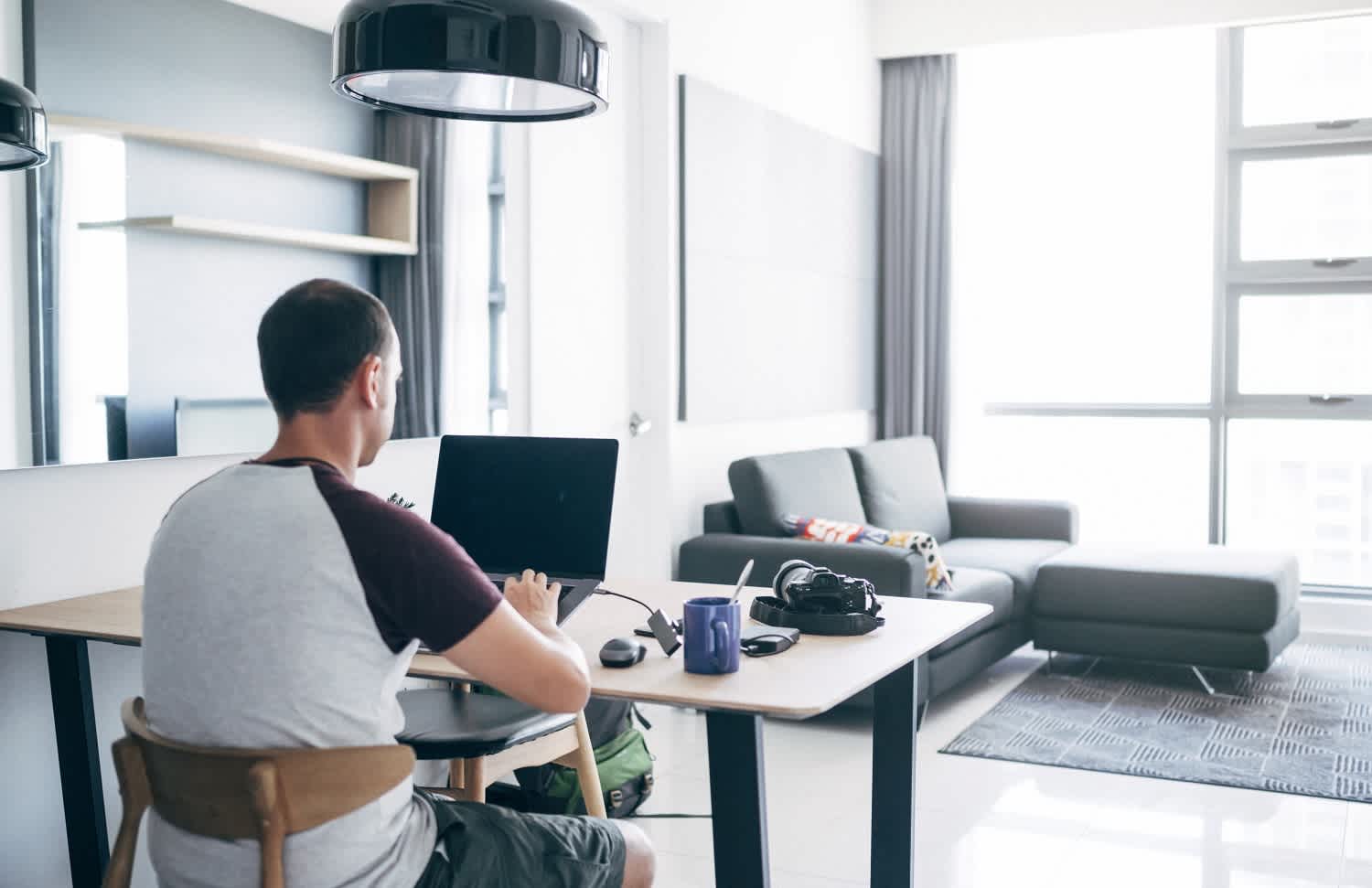 Man working at a desk in living area