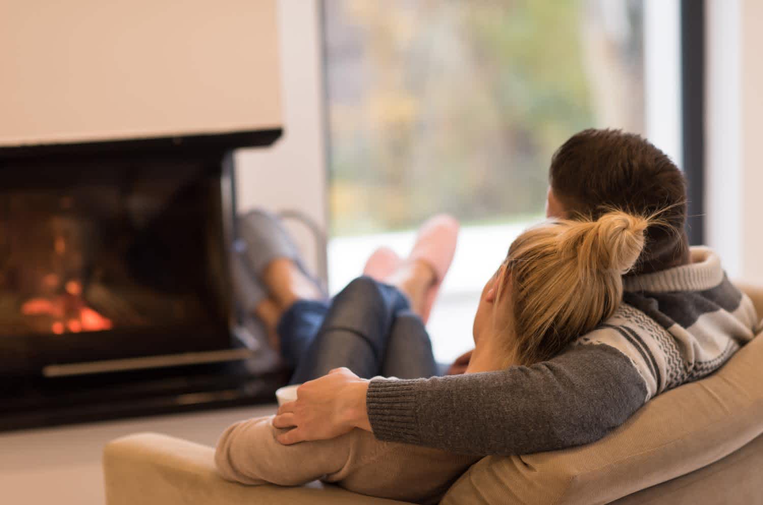 Young couple in front of fireplace