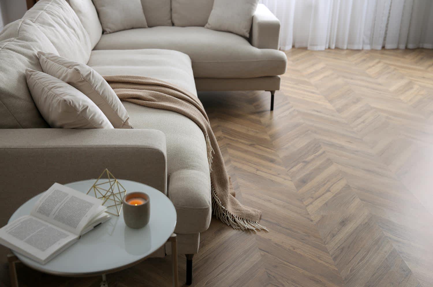 White modern couches sitting on faux wood vinyl floors