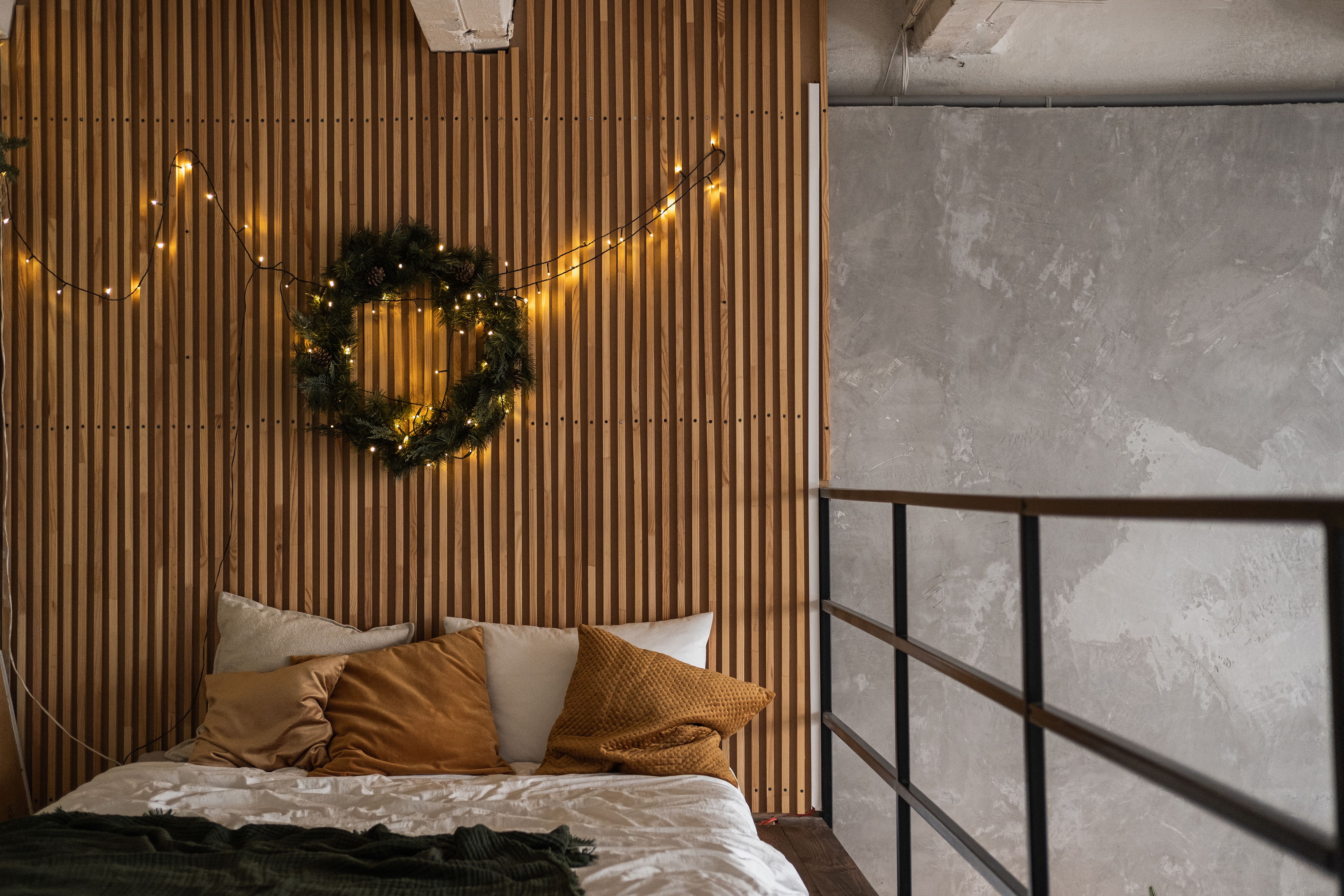 A minimalistic style bedroom with a vertical wood slat wall