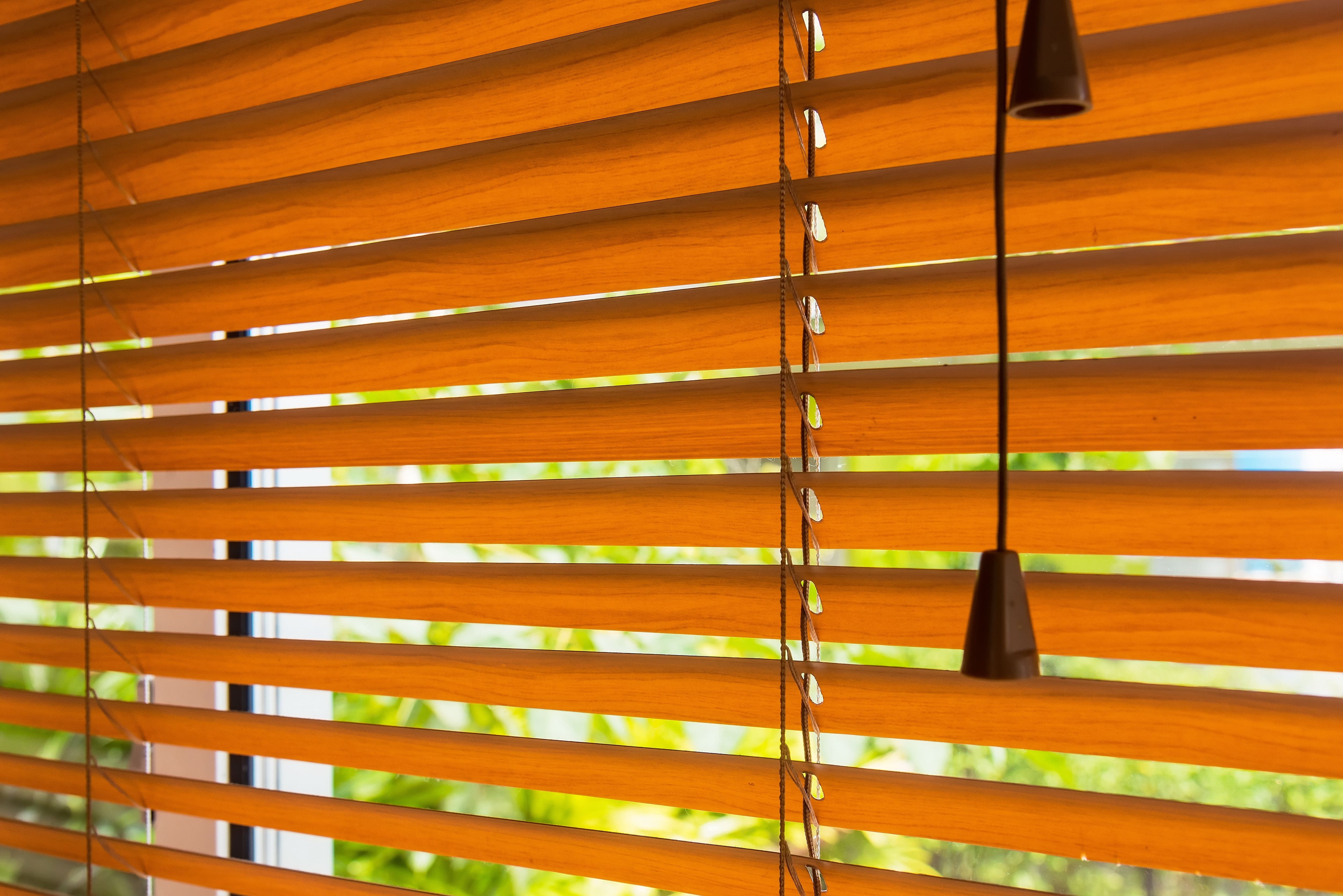 Faux wood blinds over window