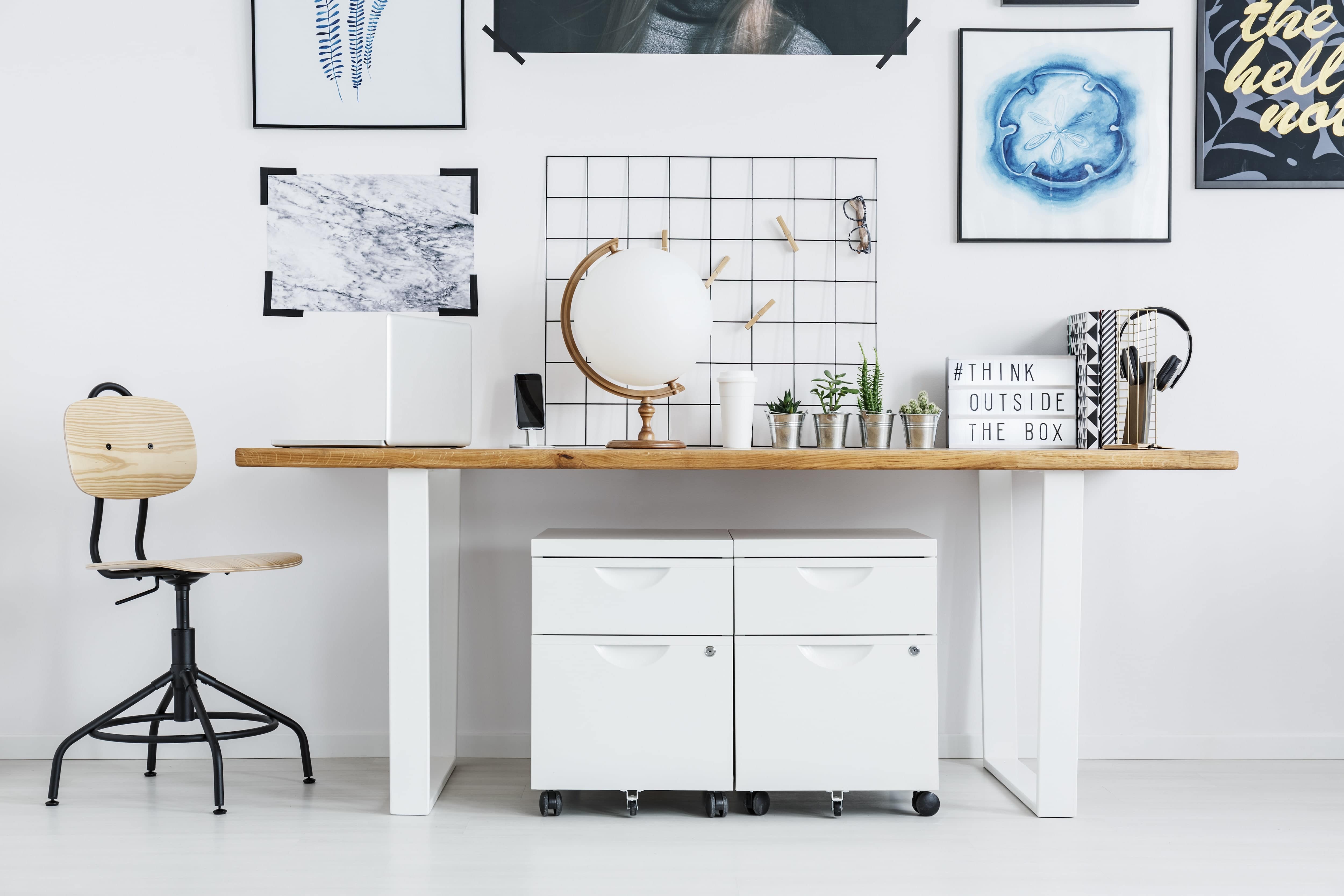 Creative home office featuring motivation wall art stickers, paintings, and quotes