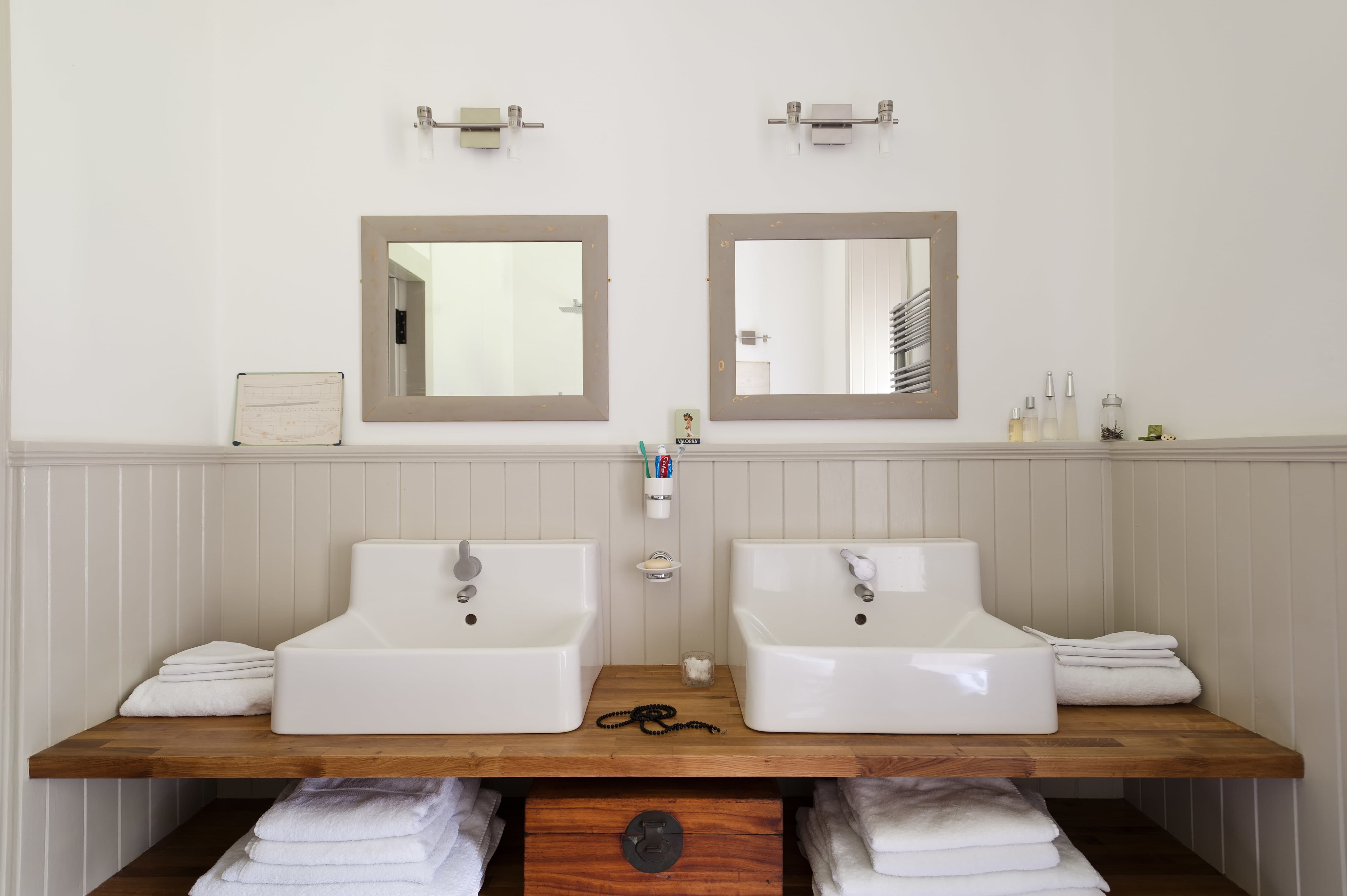 Double square mirrors hung above double vanity