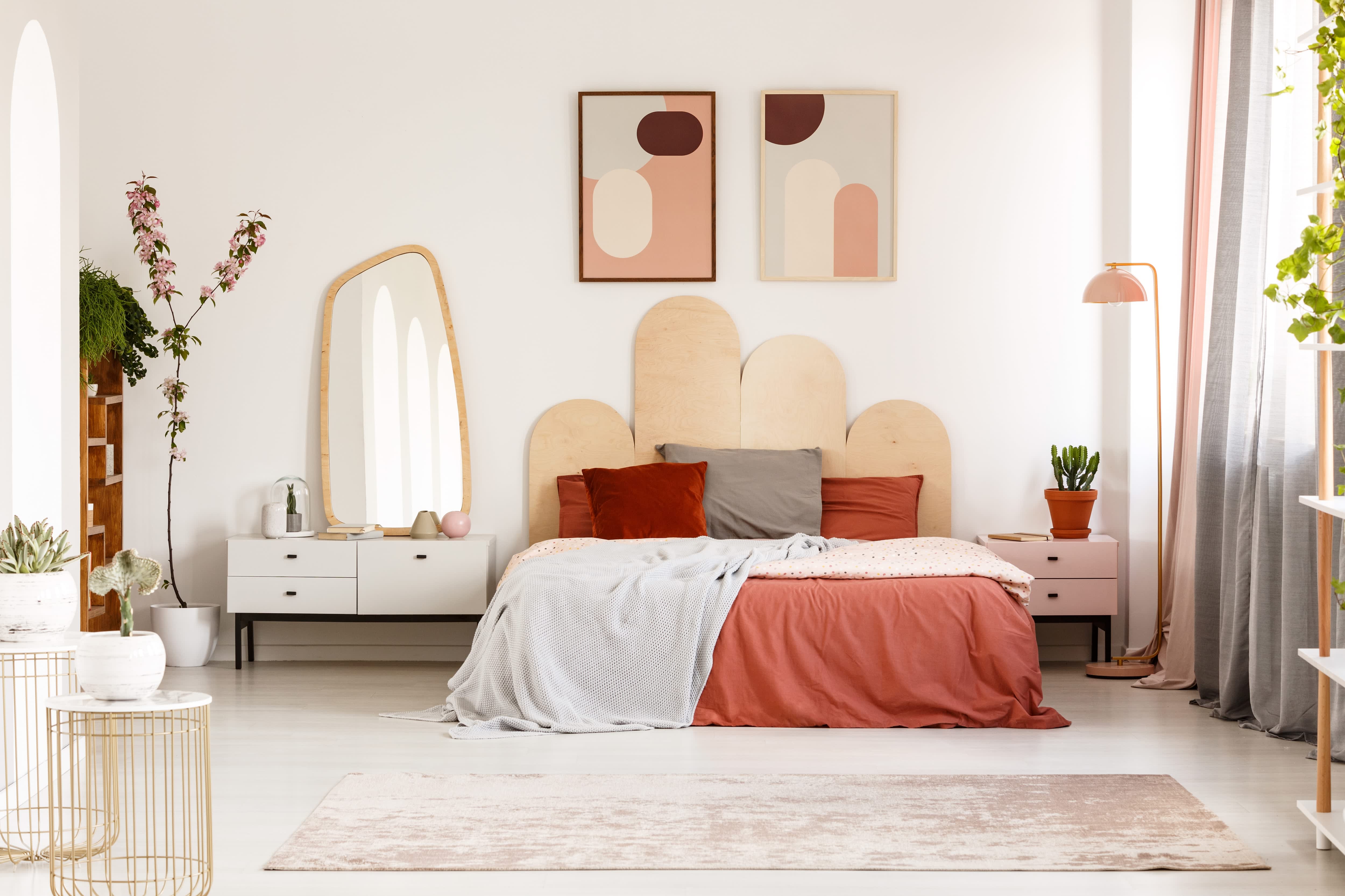 A modern bedroom with a headboard made from four rounded wood slabs