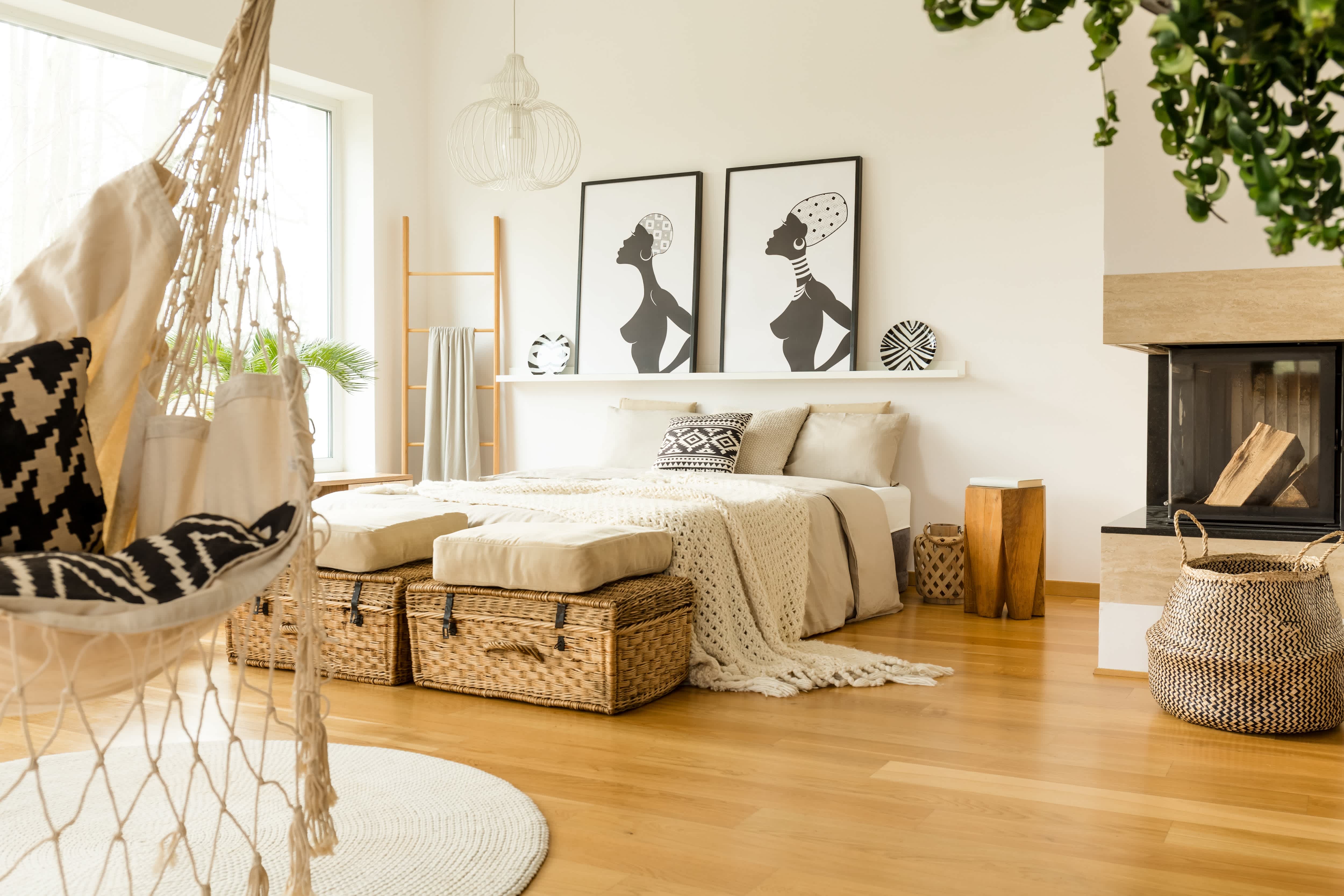 A boho bedroom with large framed artwork on shelving above the bed