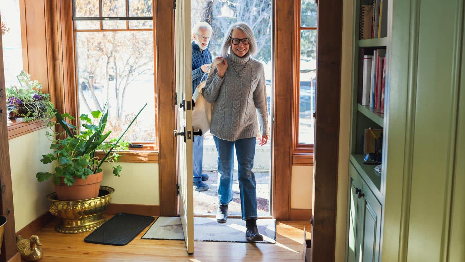 A senior couple arriving at their home