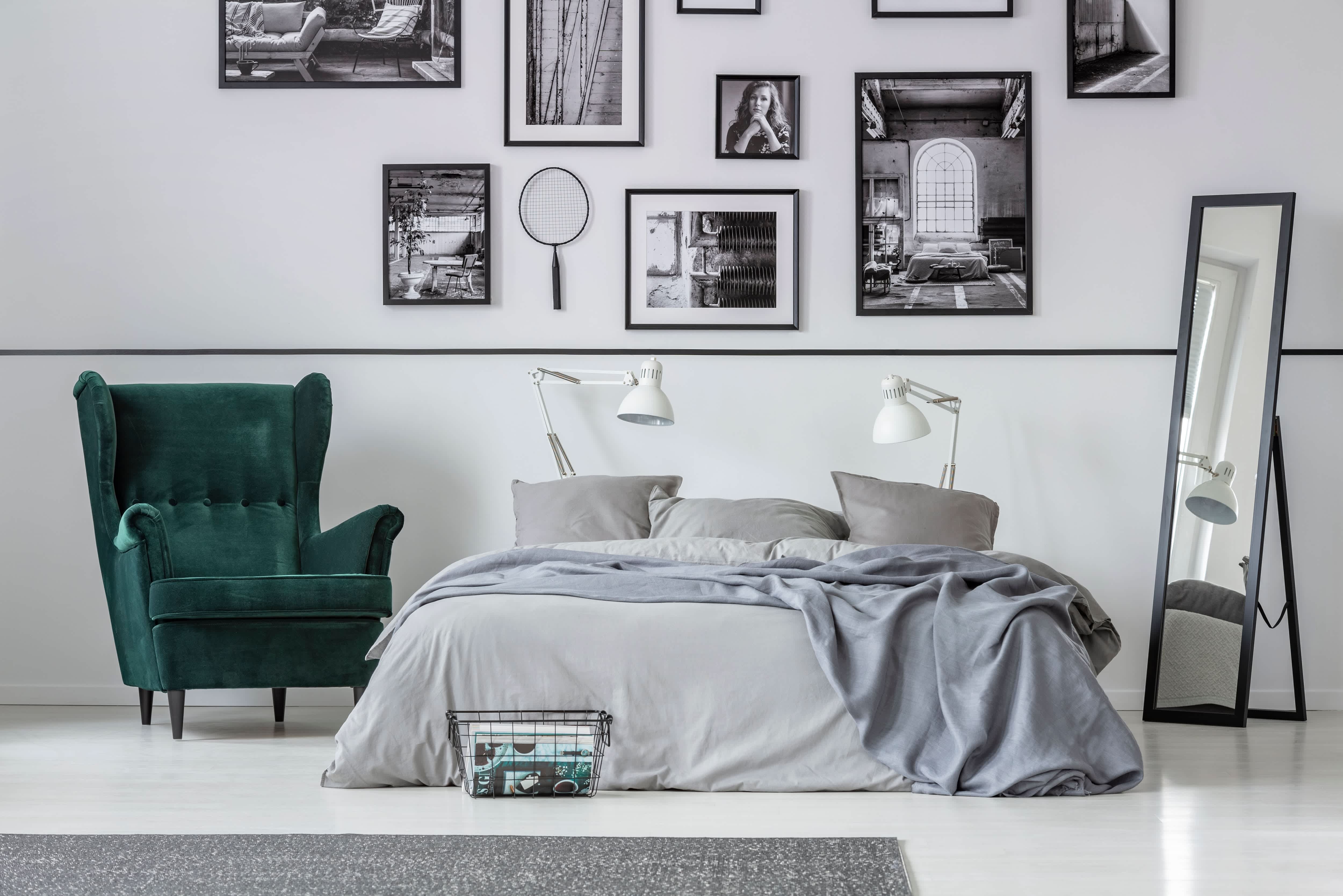 A modern bedroom with a large photo gallery wall above the bed