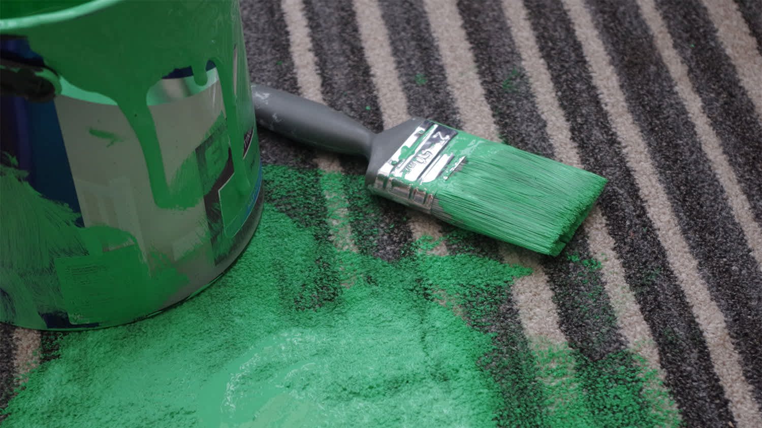 bucket of green paint on the carpet