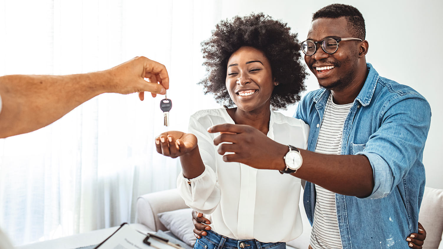 Smiling couple receiving keys
