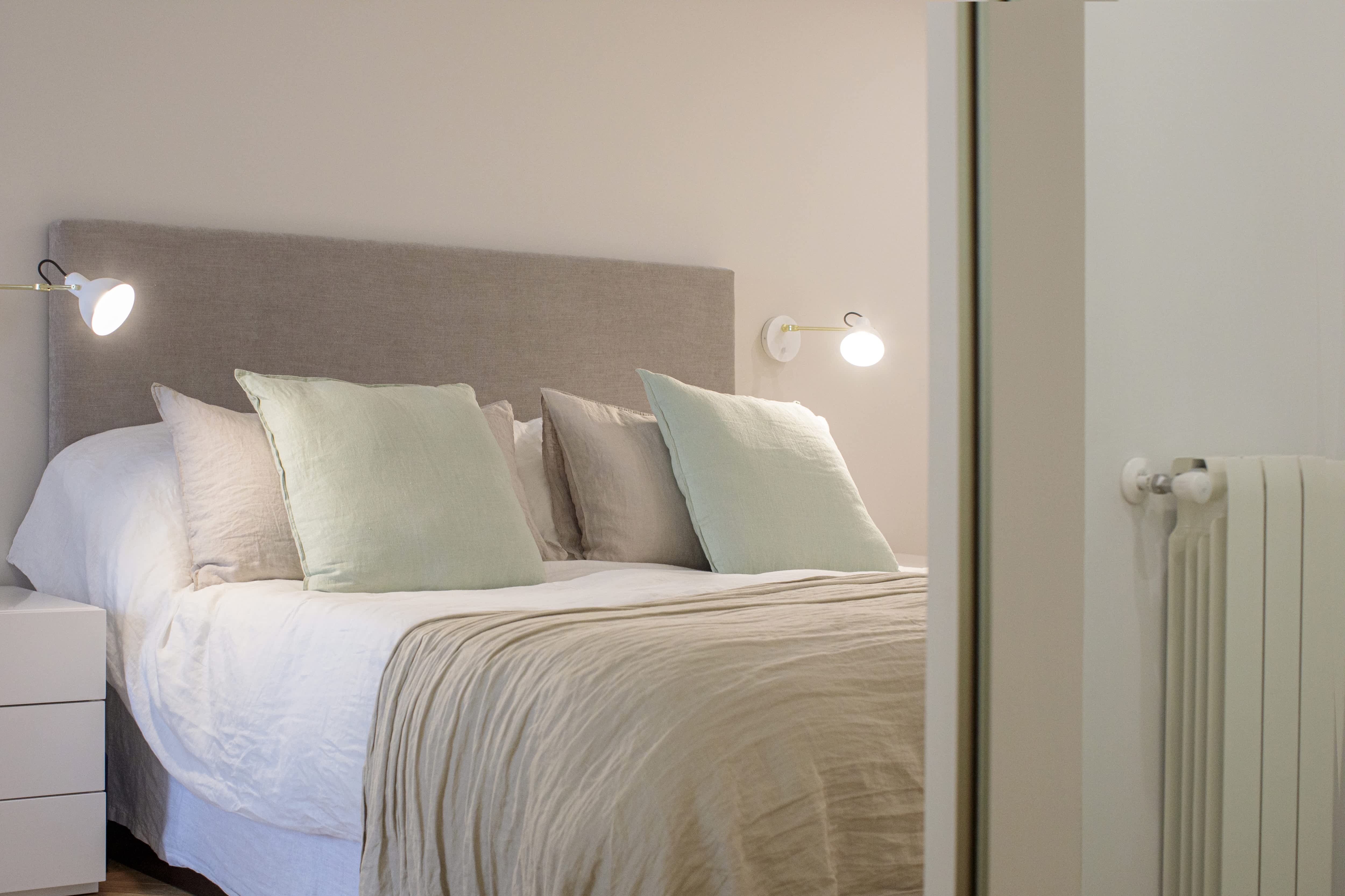 A simple bedroom with a full bed and a no-sew headboard