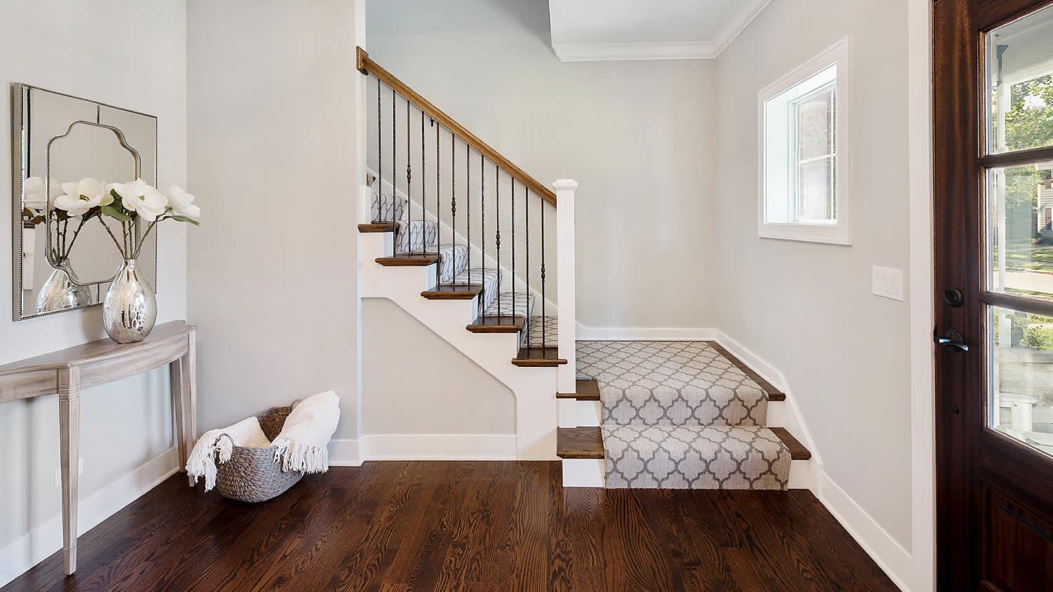 Home entryway with hardwood floor and console table