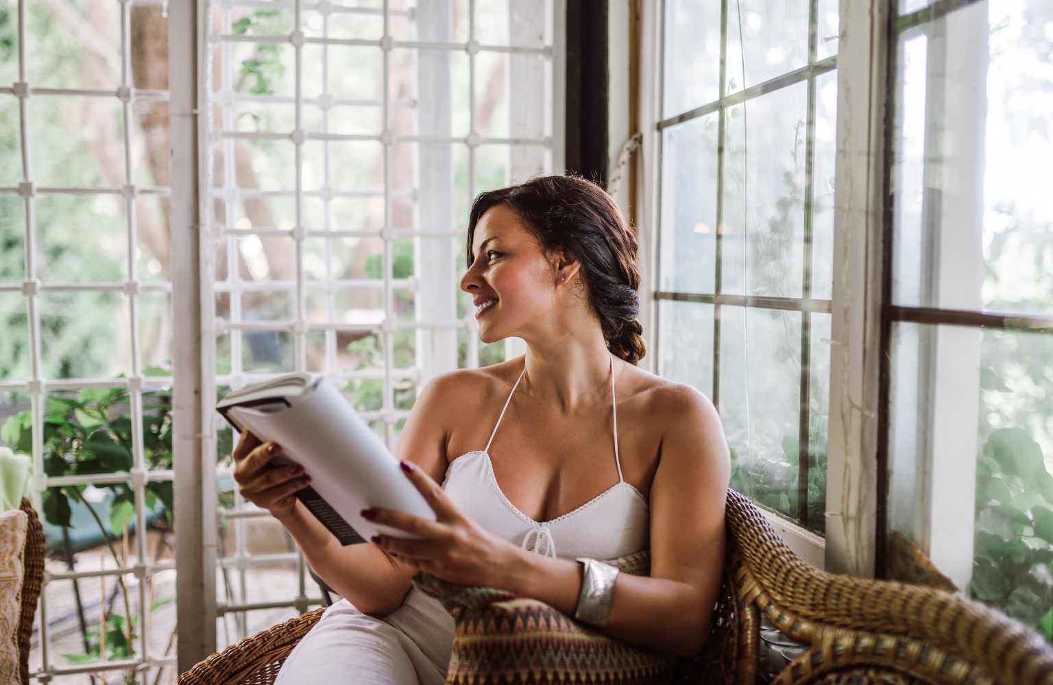 woman reading in sunroom