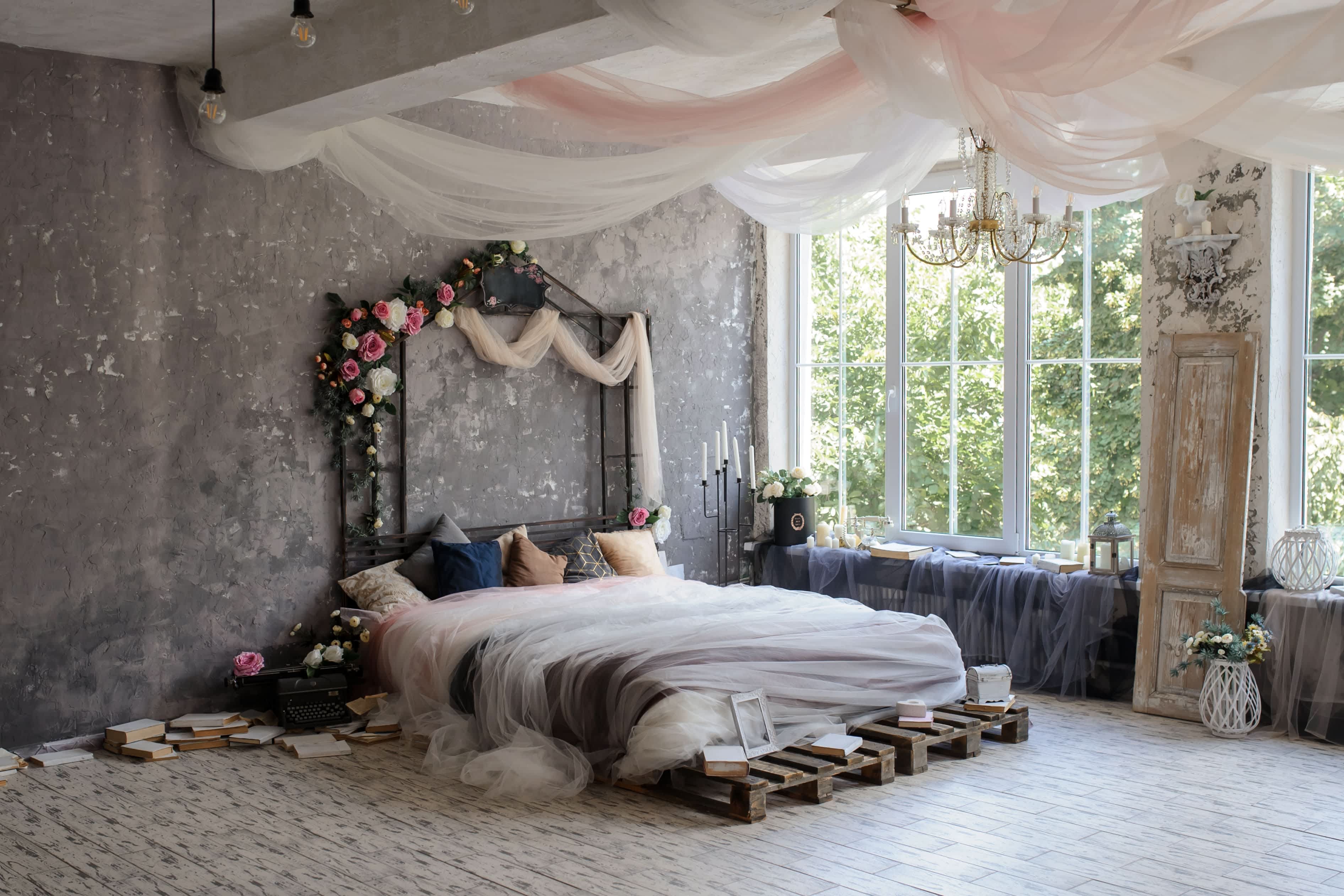 A bed with a metal arbor headboard in a whimsical bedroom