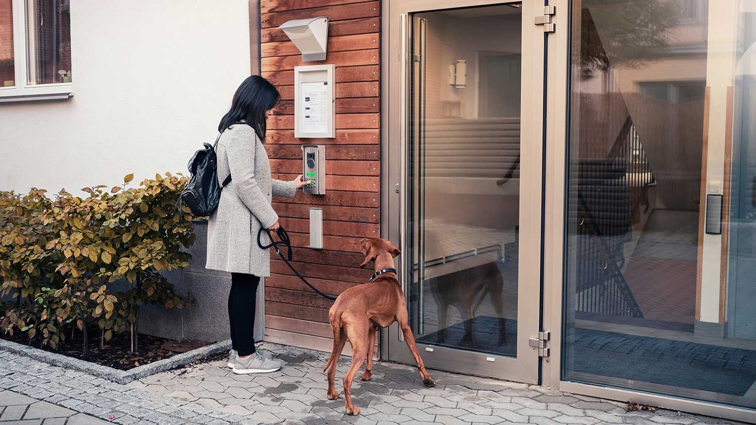 Woman opening apartment entrance door