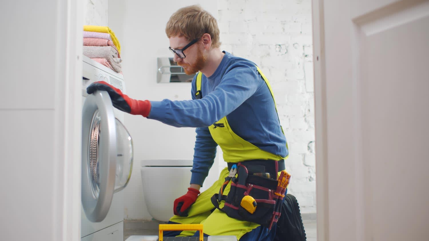 Repairman fixing broken washer