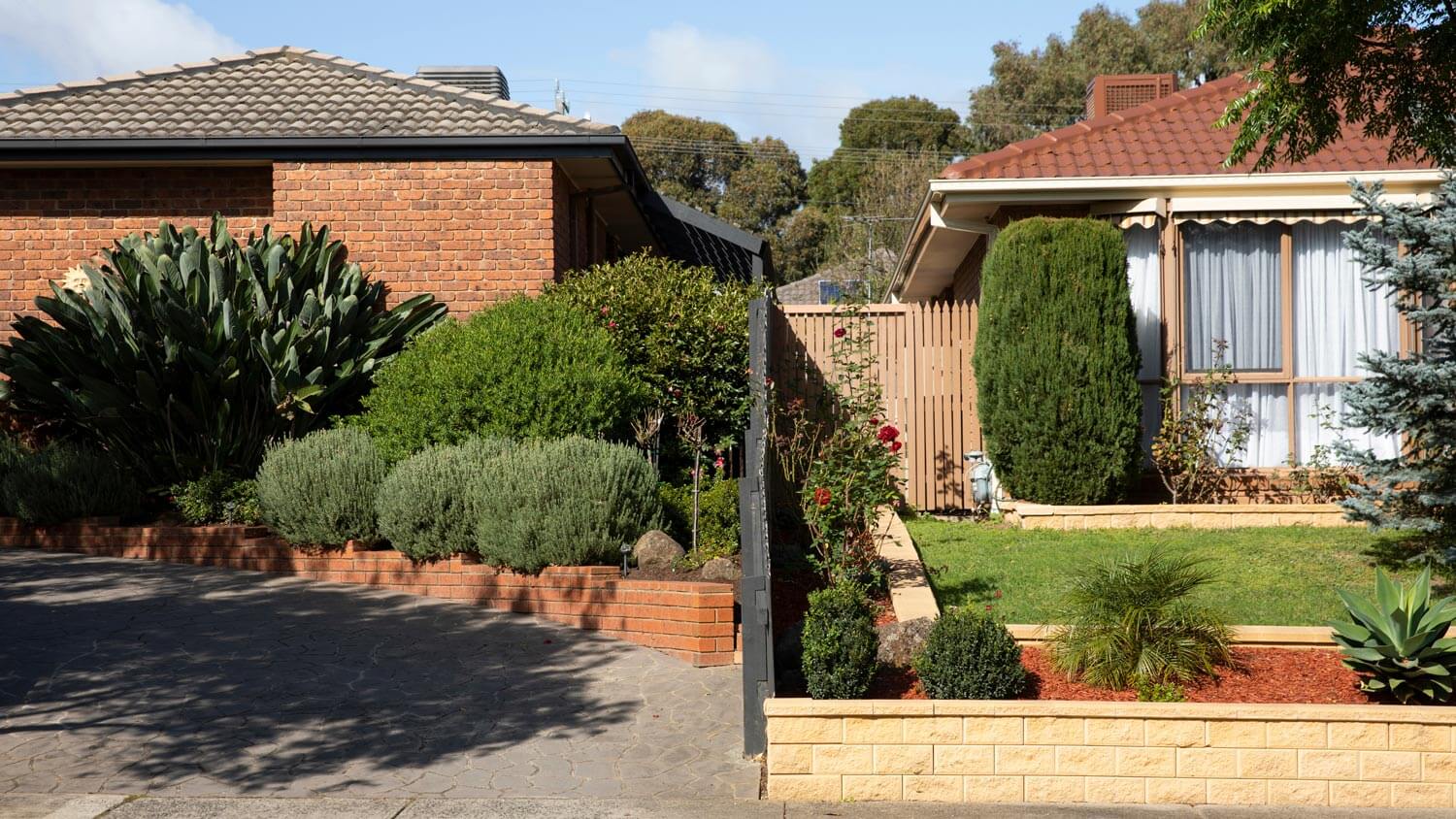 A fence line separating two houses