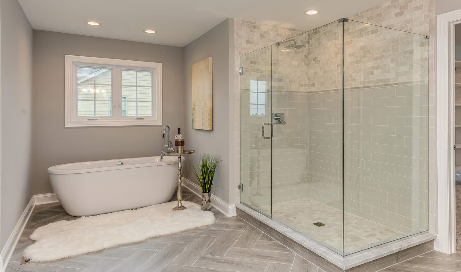 Master bathroom with natural tile and freestanding tub