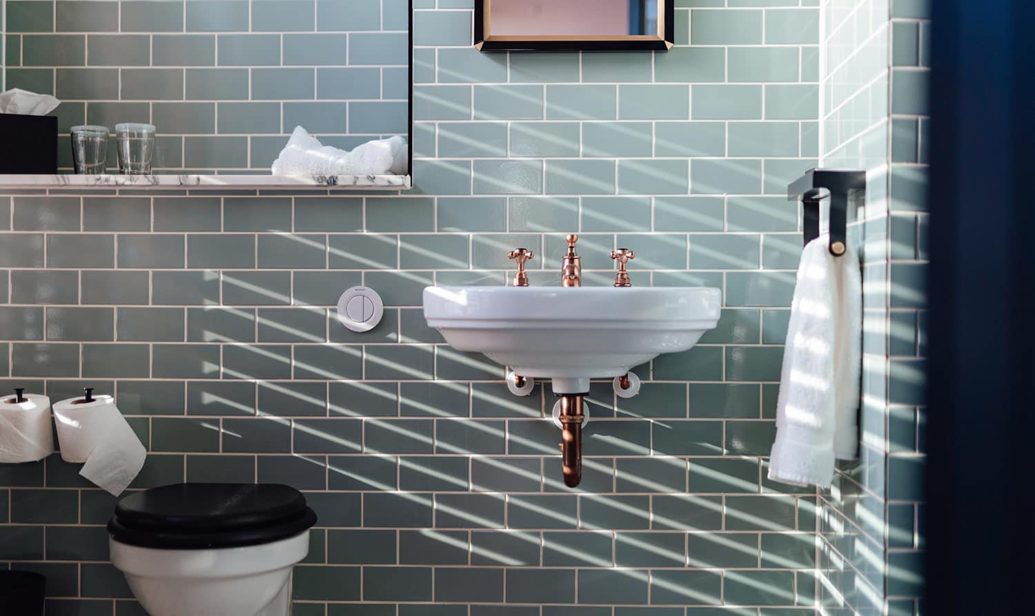 Blue subway tile in small bathroom