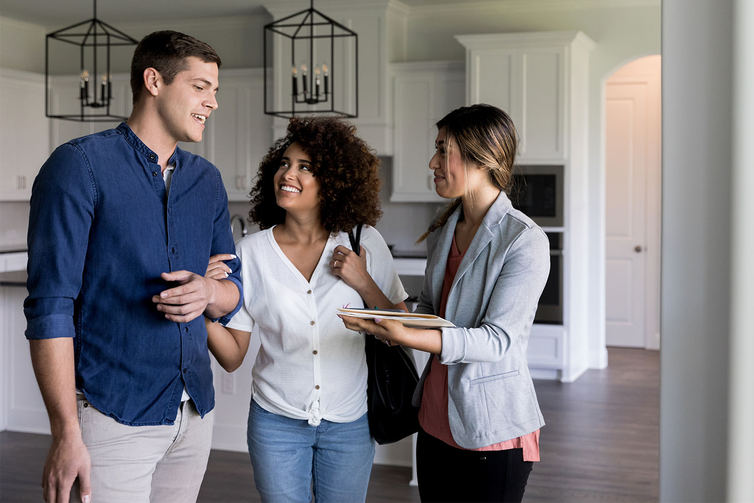 realtor showing couple apartment