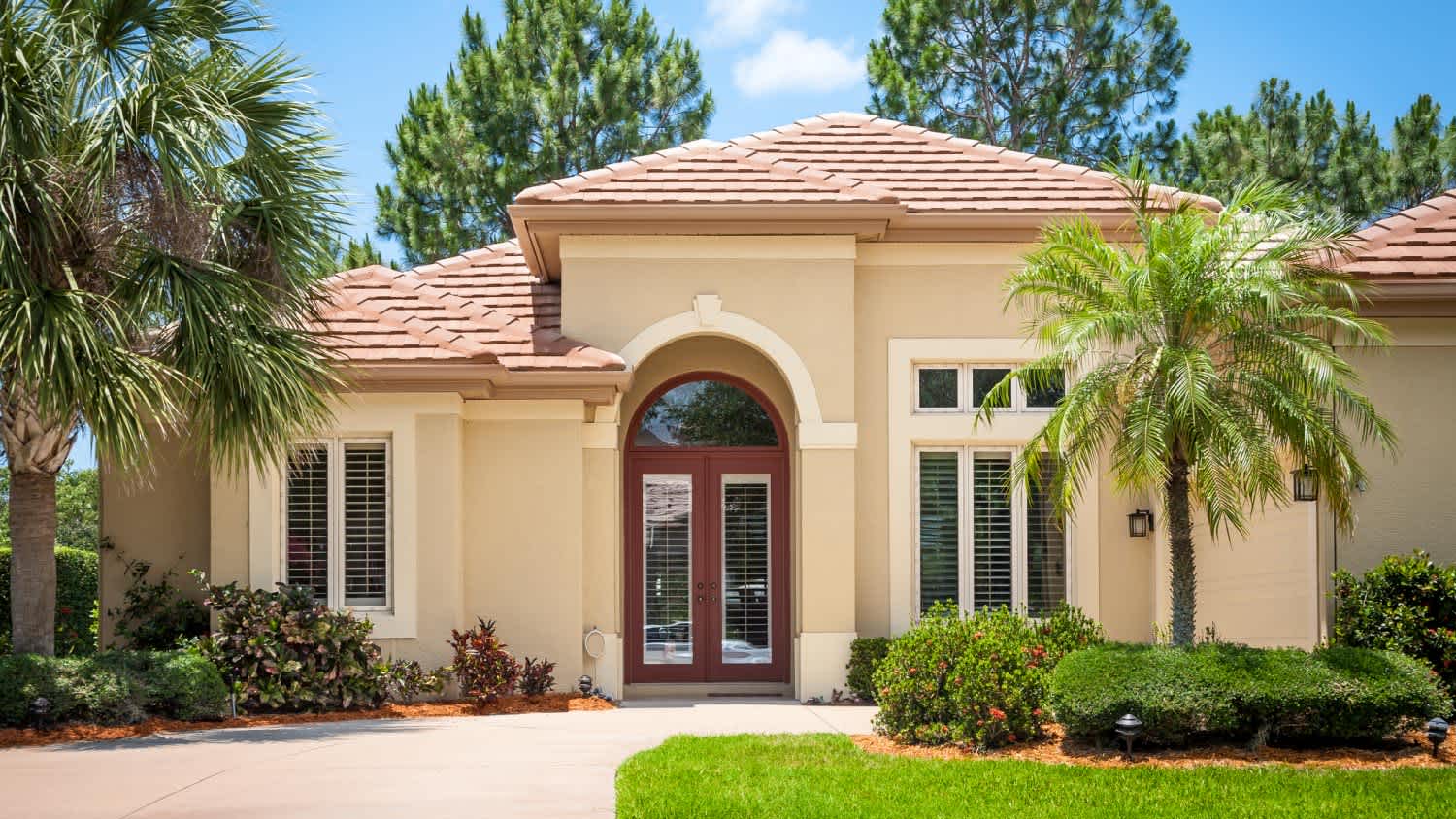 A beautiful house with tiled roof and palm trees