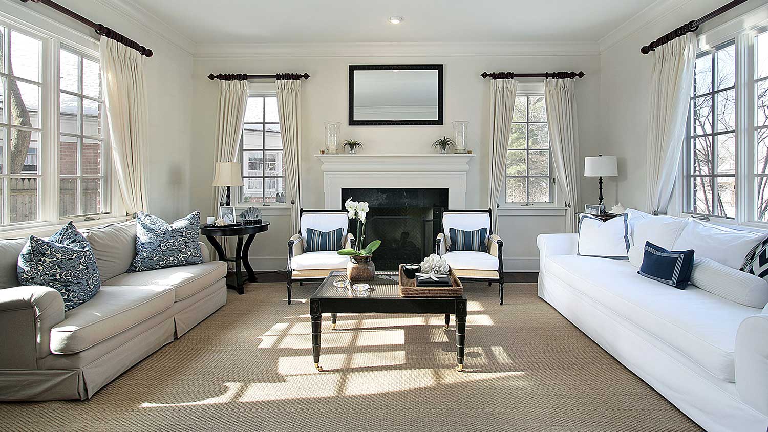 Windows along three walls in living room of traditional home