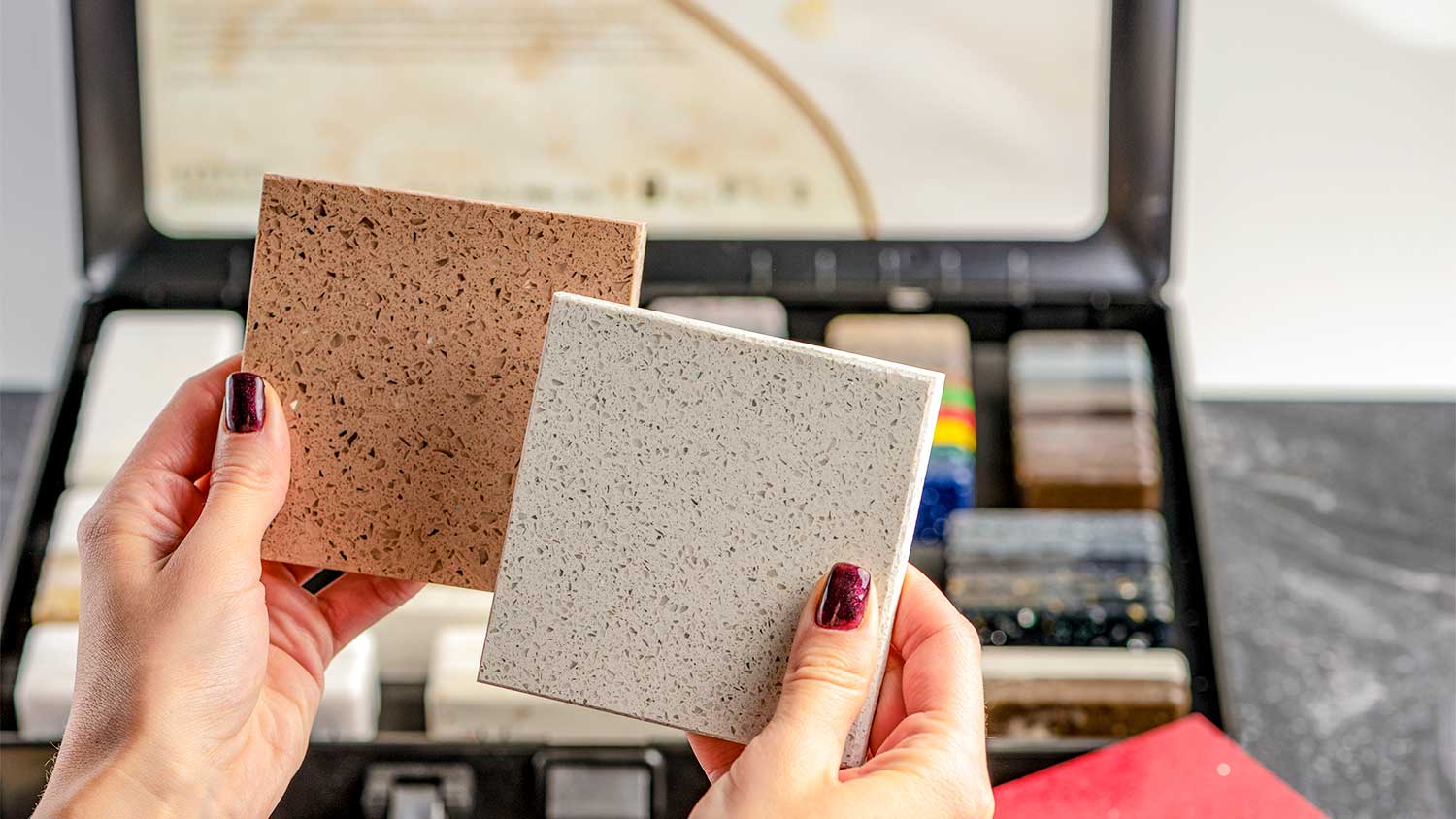 Hands hold terrazzo samples