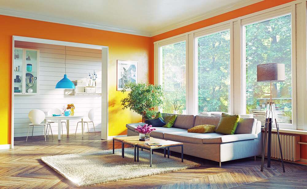 Brightly orange painted livingroom with white trim