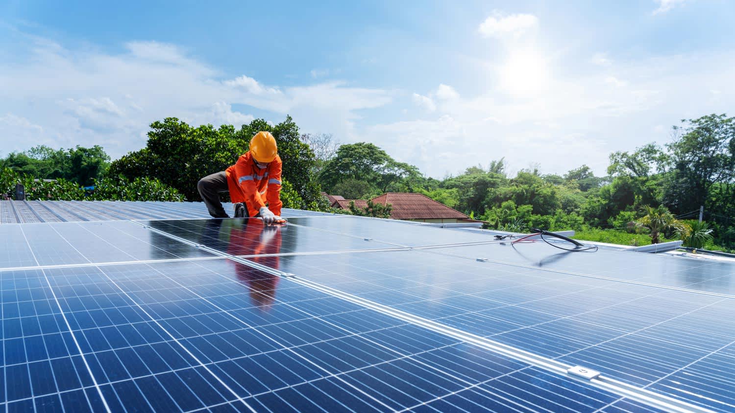 A technician installing new solar panels on a roof