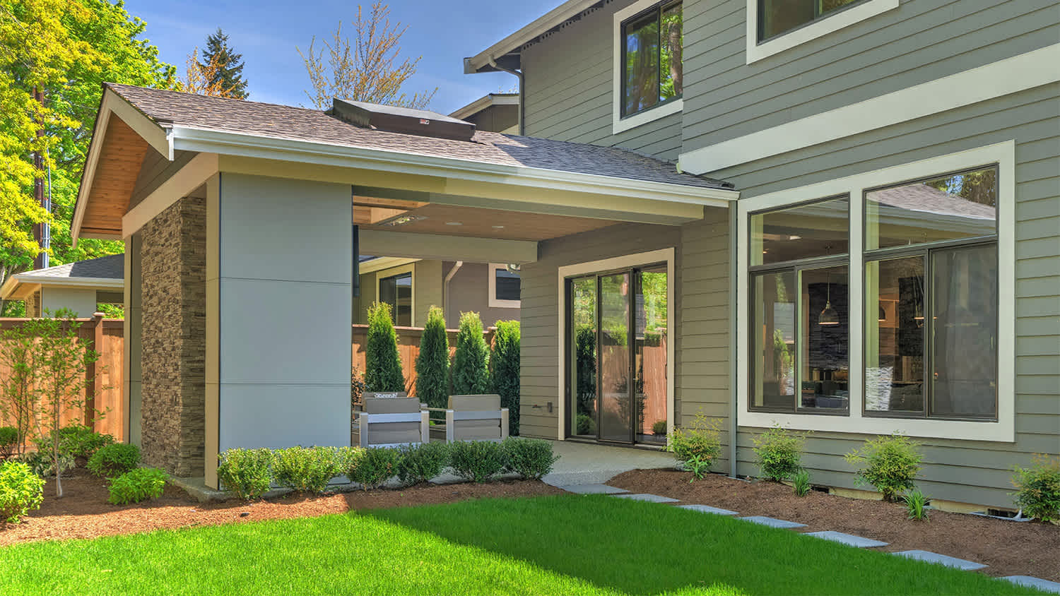 grey house with porch and backyard