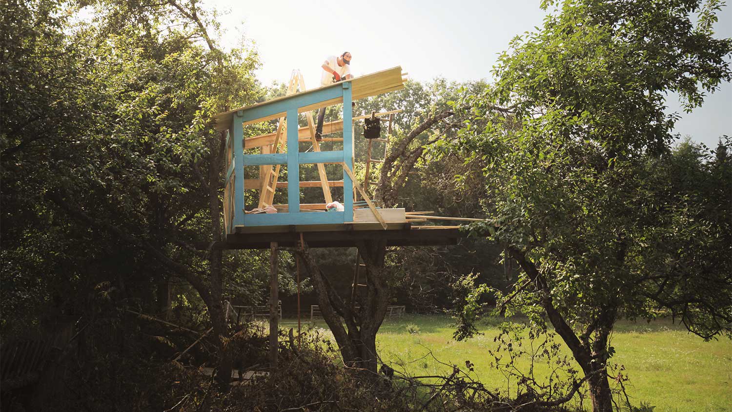 A man building a treehouse