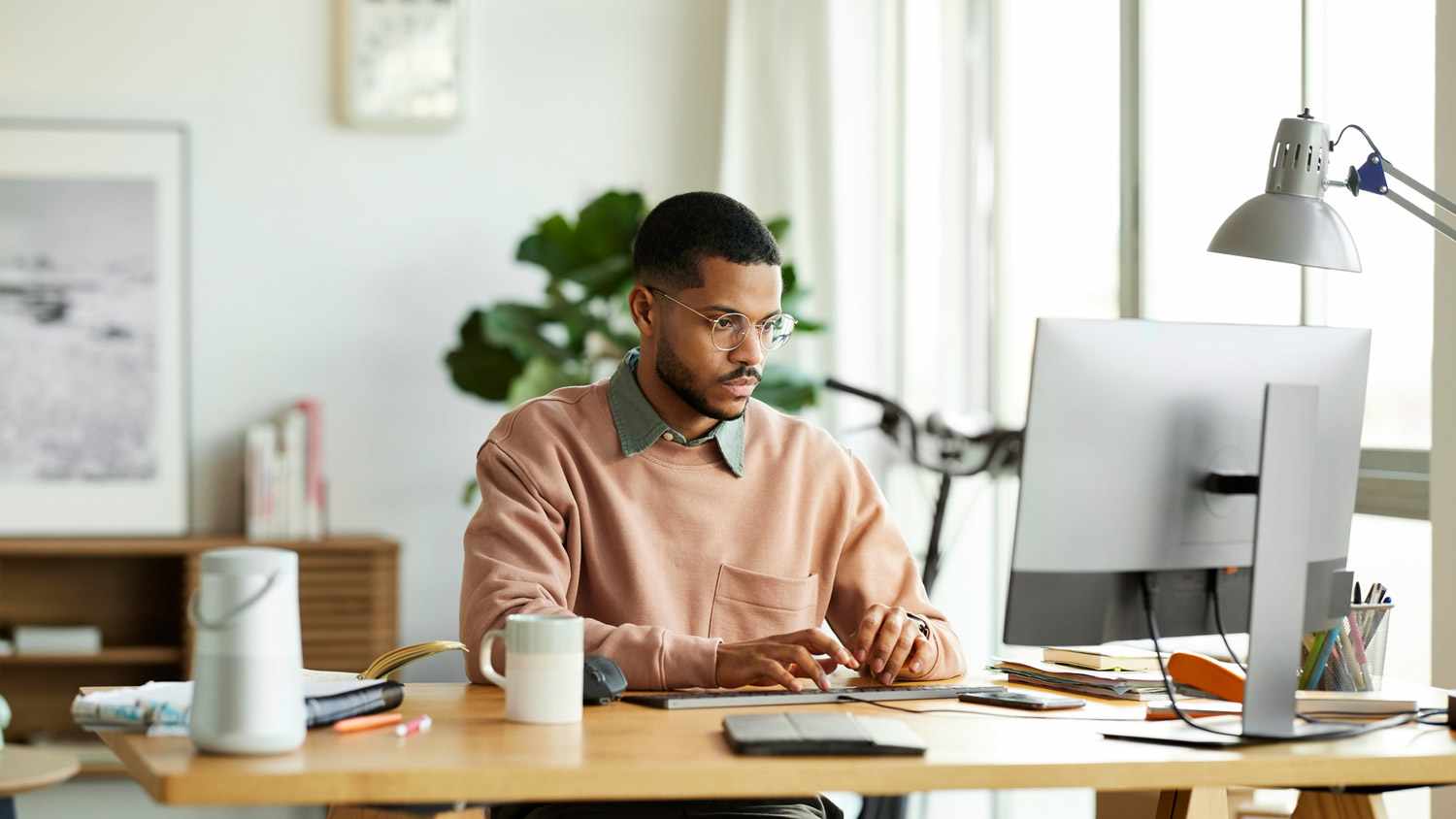 A young man working from his home office