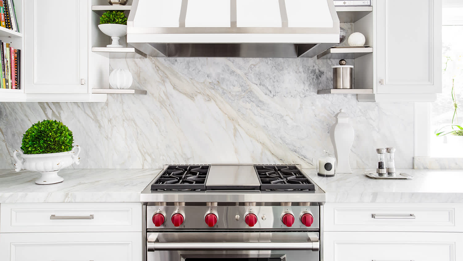 white marble kitchen with gas stove range