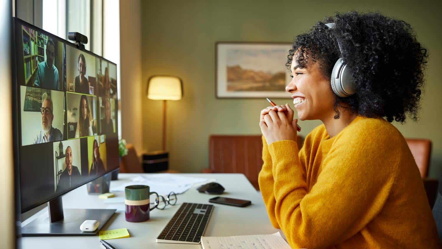 A woman having a video conference with colleagues in home office