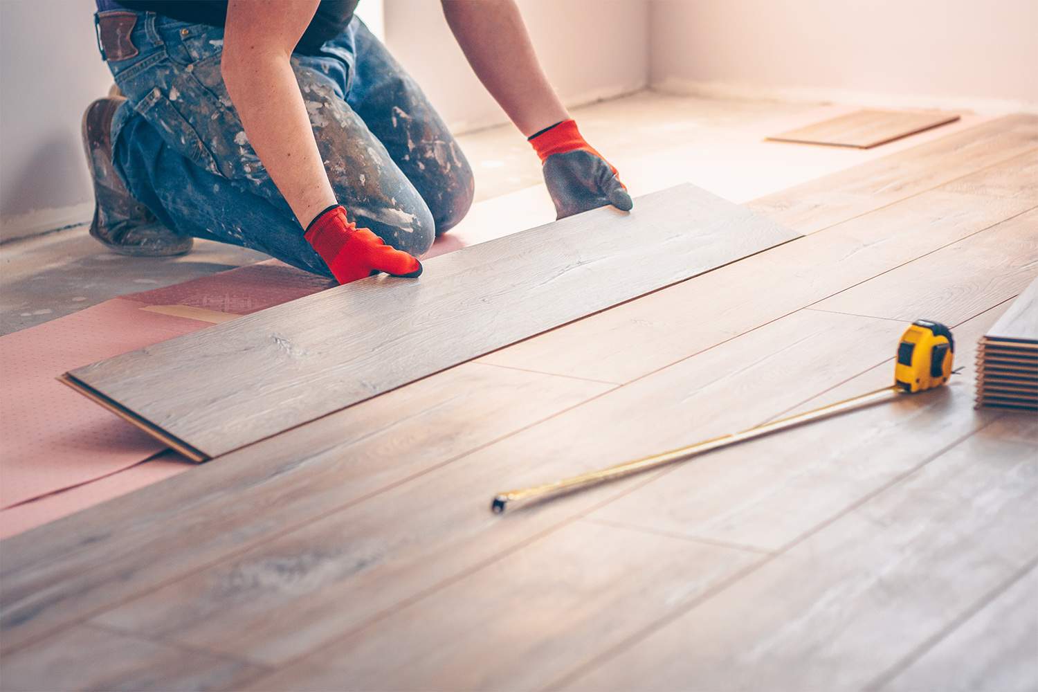 Professional installing flooring in home