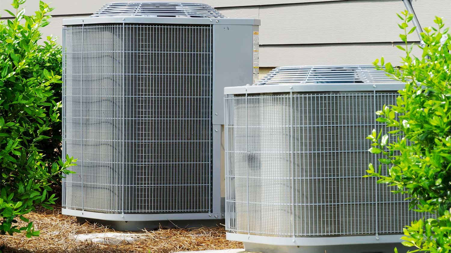 Two air conditioners outside a home