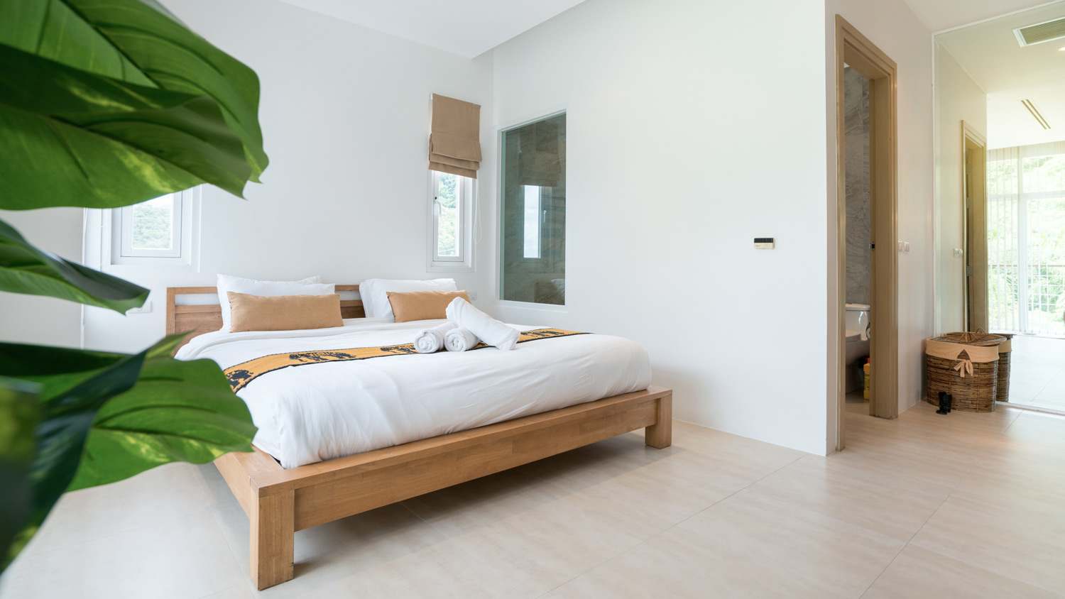 A luxury bedroom with a cozy king bed and a conventional ceiling