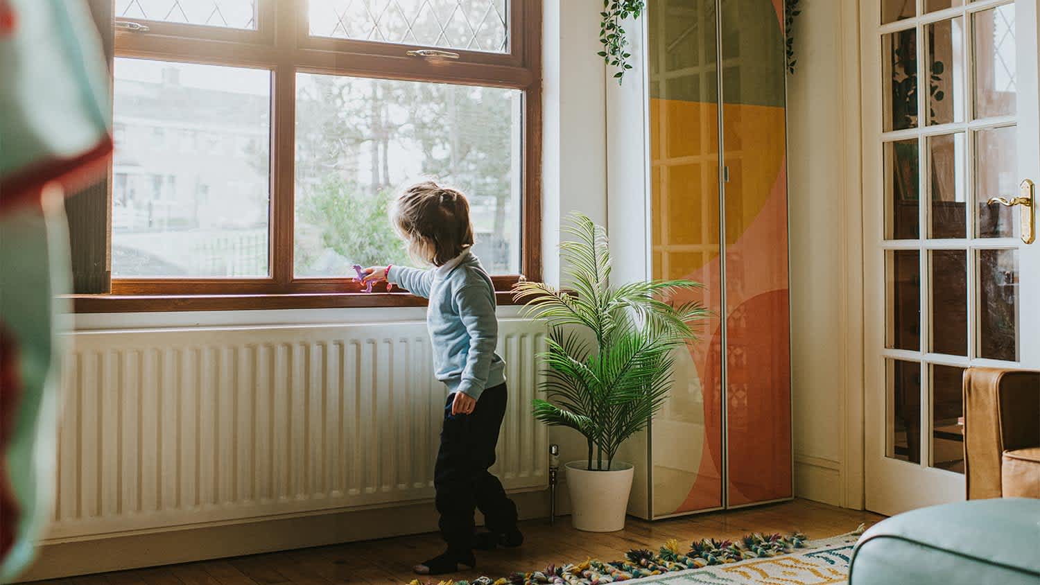 Child playing near window