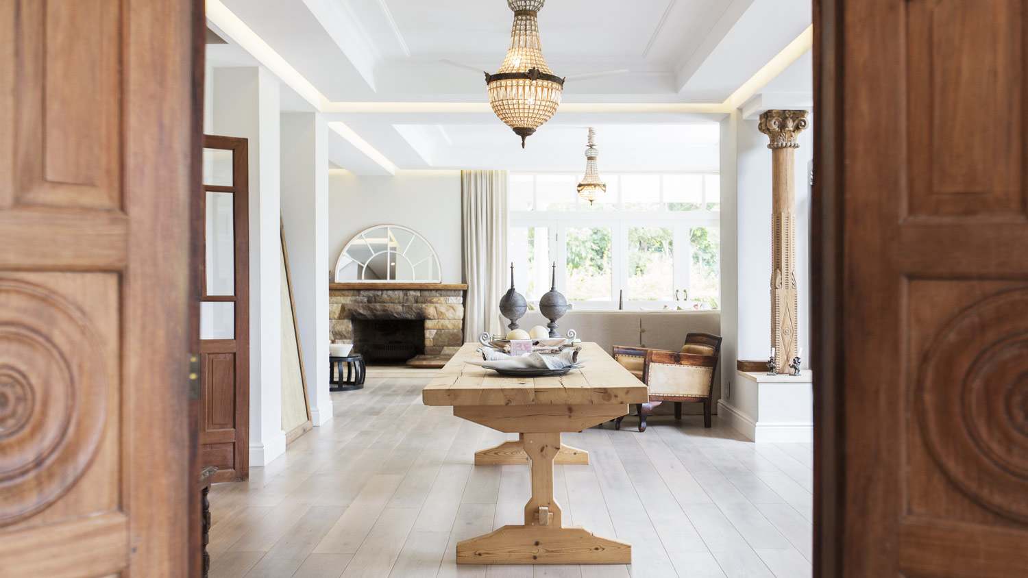 Wooden doors leading to dining room with a tray ceiling