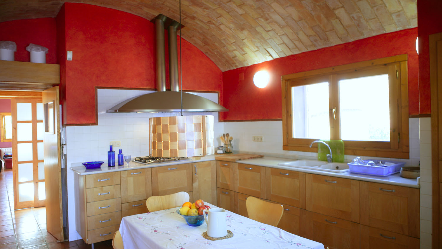 A kitchen with a wooden barrel vault ceiling