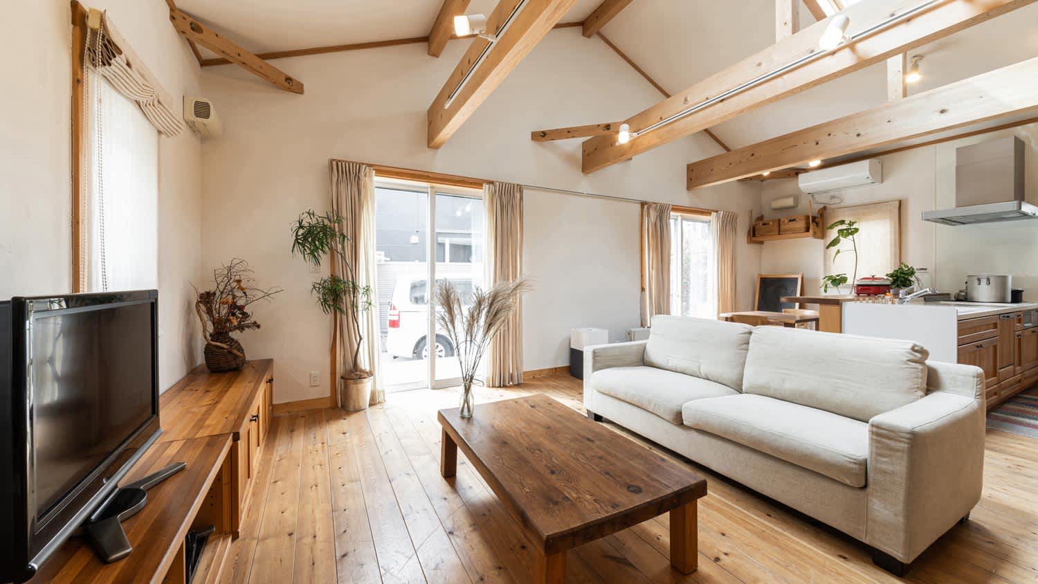 A living room with a beamed ceiling