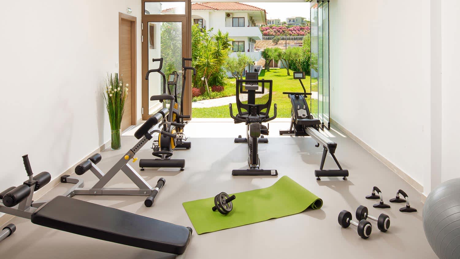 A modern home gym with a window facing the garden