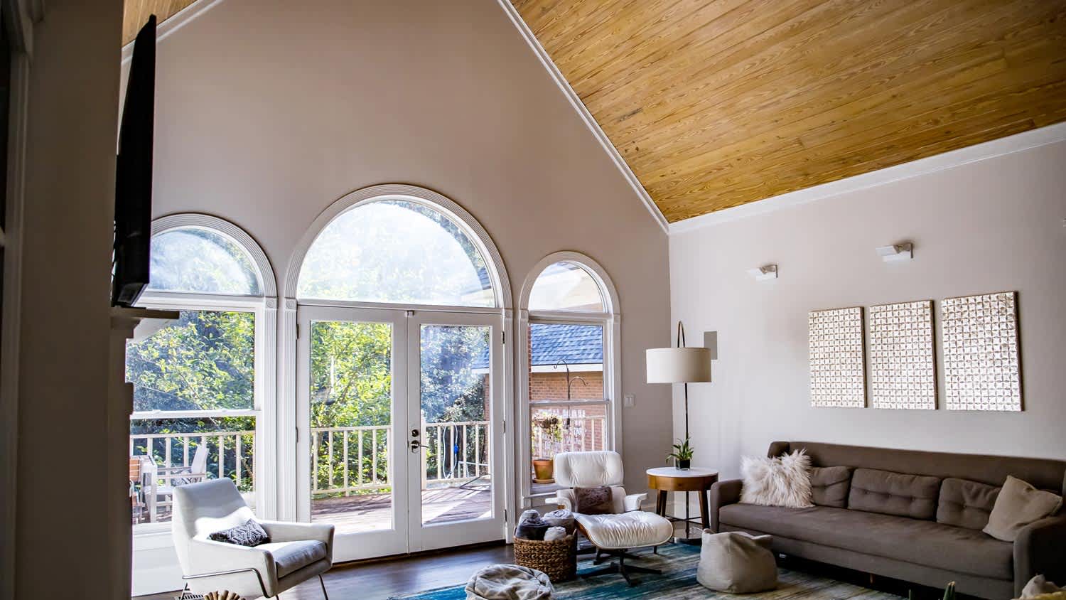 Bright living room with a pine wood vaulted ceiling