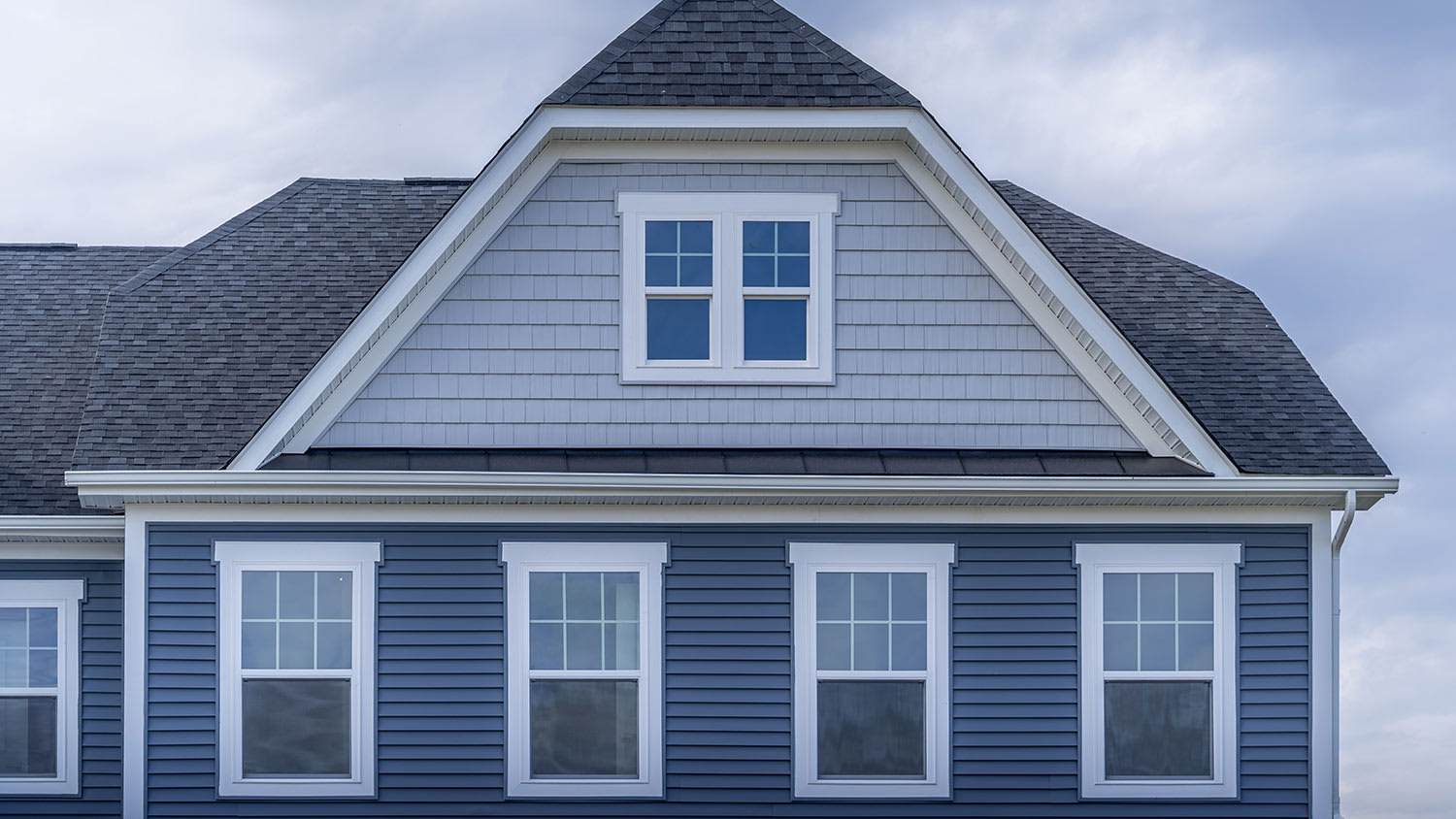 Shingles on a gabled roof of a brick house