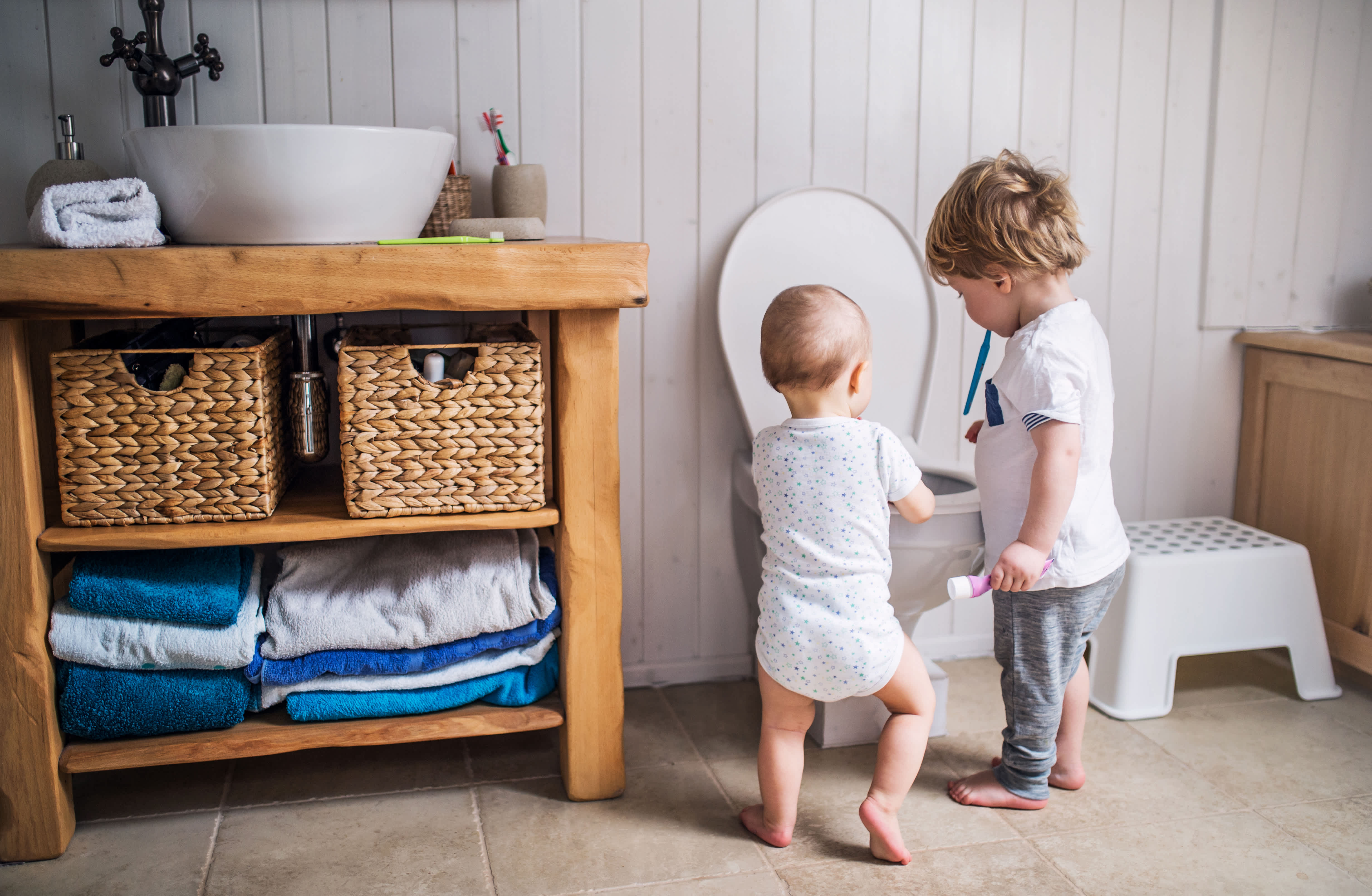 Children look at a toilet