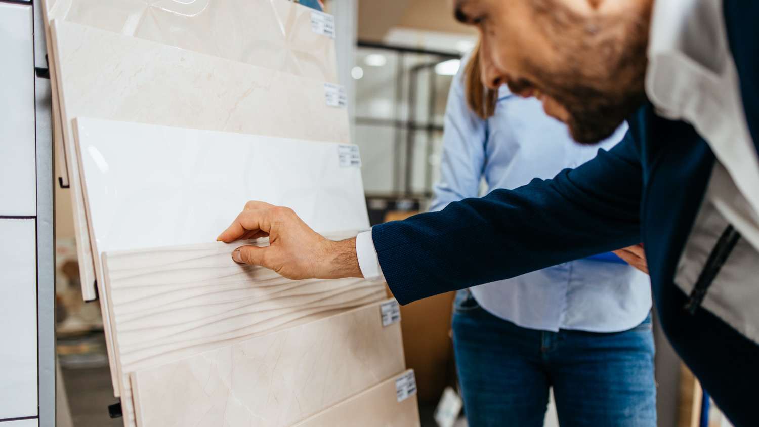 An elegant man selecting bathroom tiles for his home