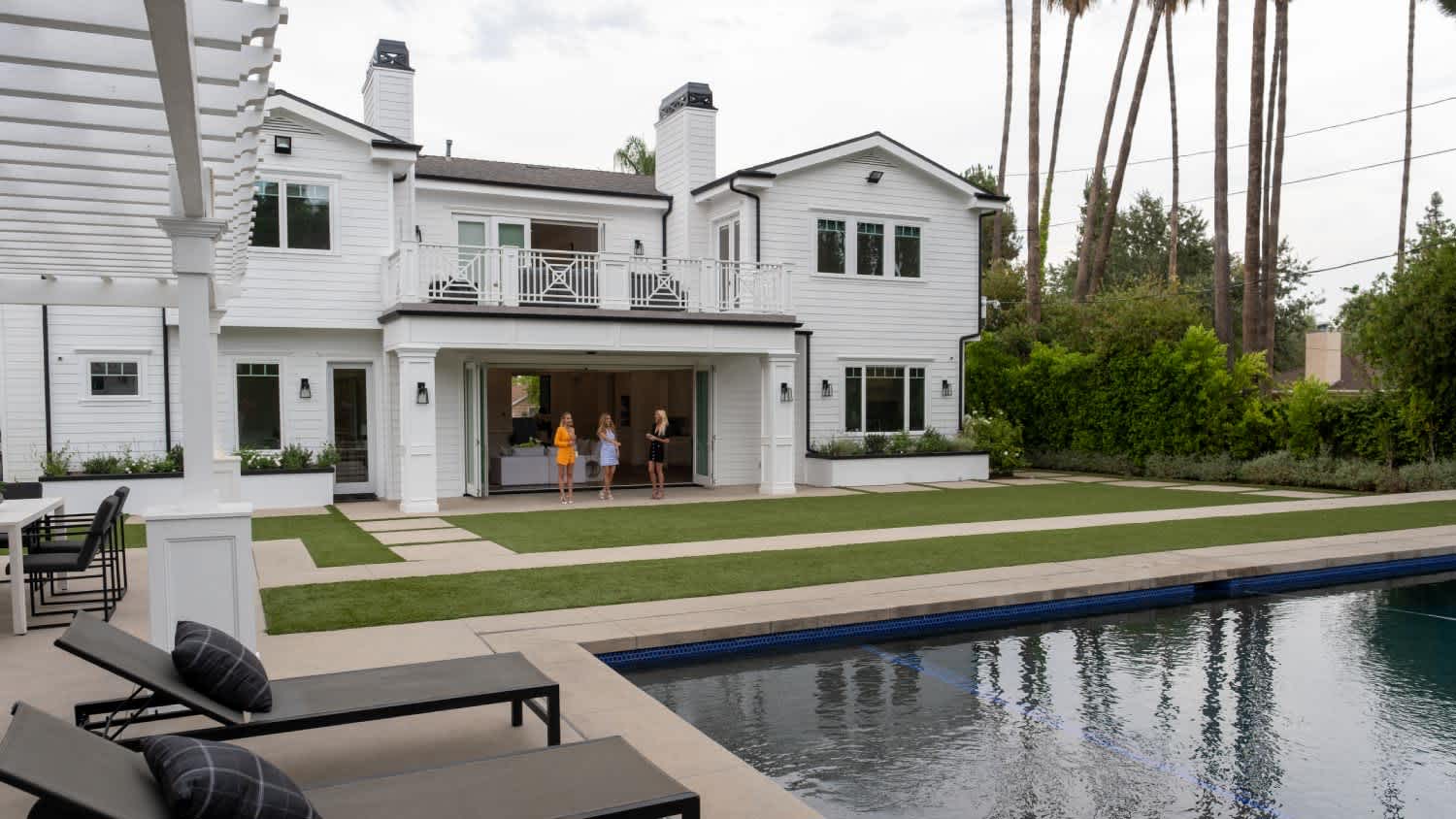 A white house with a huge backyard