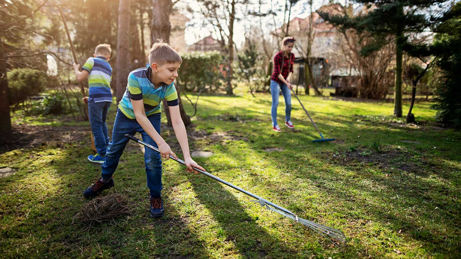 Children helping with yard spring cleaning